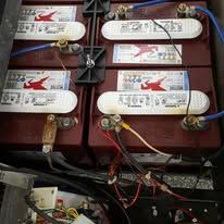 A bank of deep-cycle batteries installed and wired in a golf cart