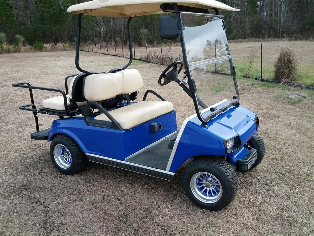 Bright blue Island Cart rental parked on the grass
